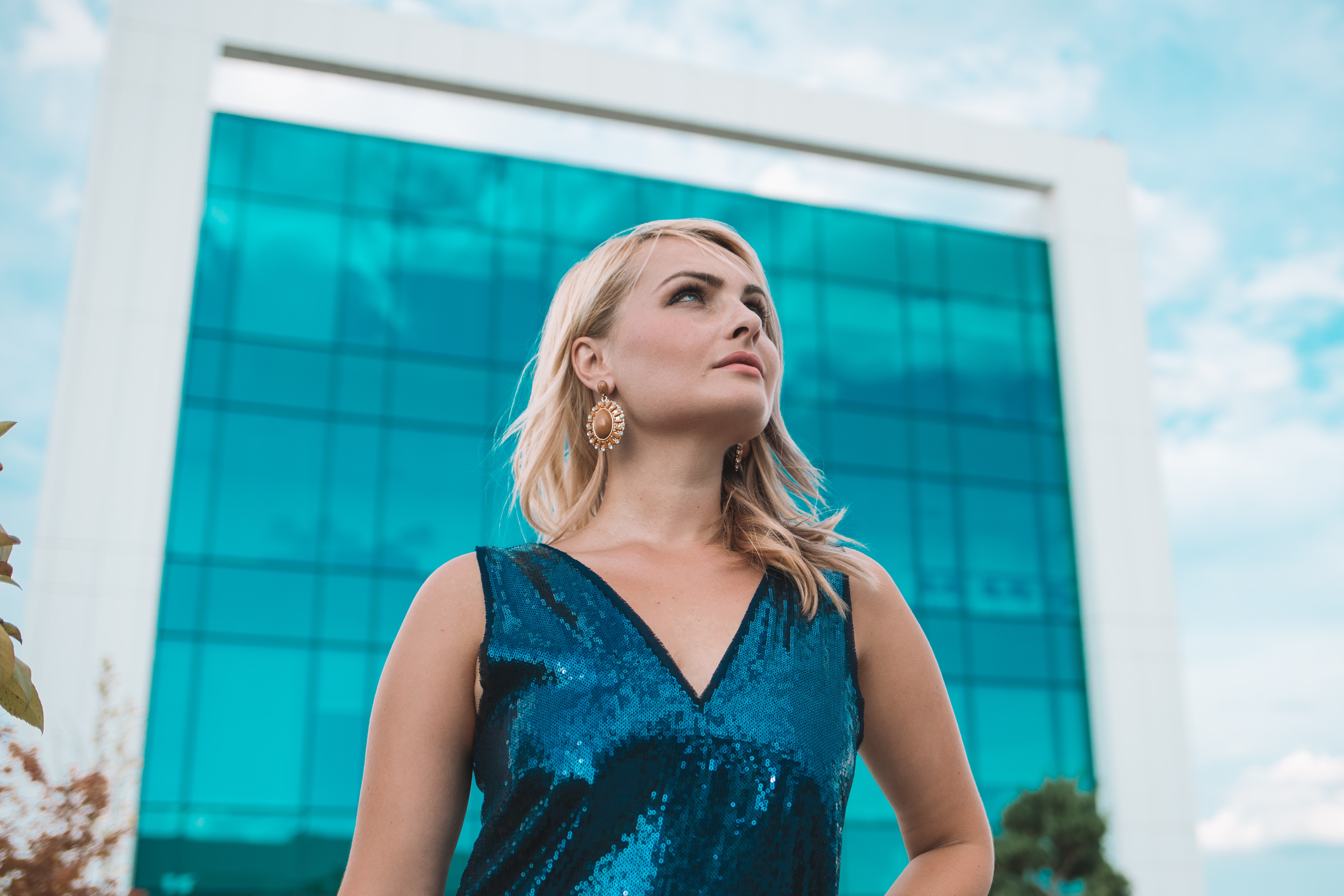 woman standing in front of building - july 2019 real estate news