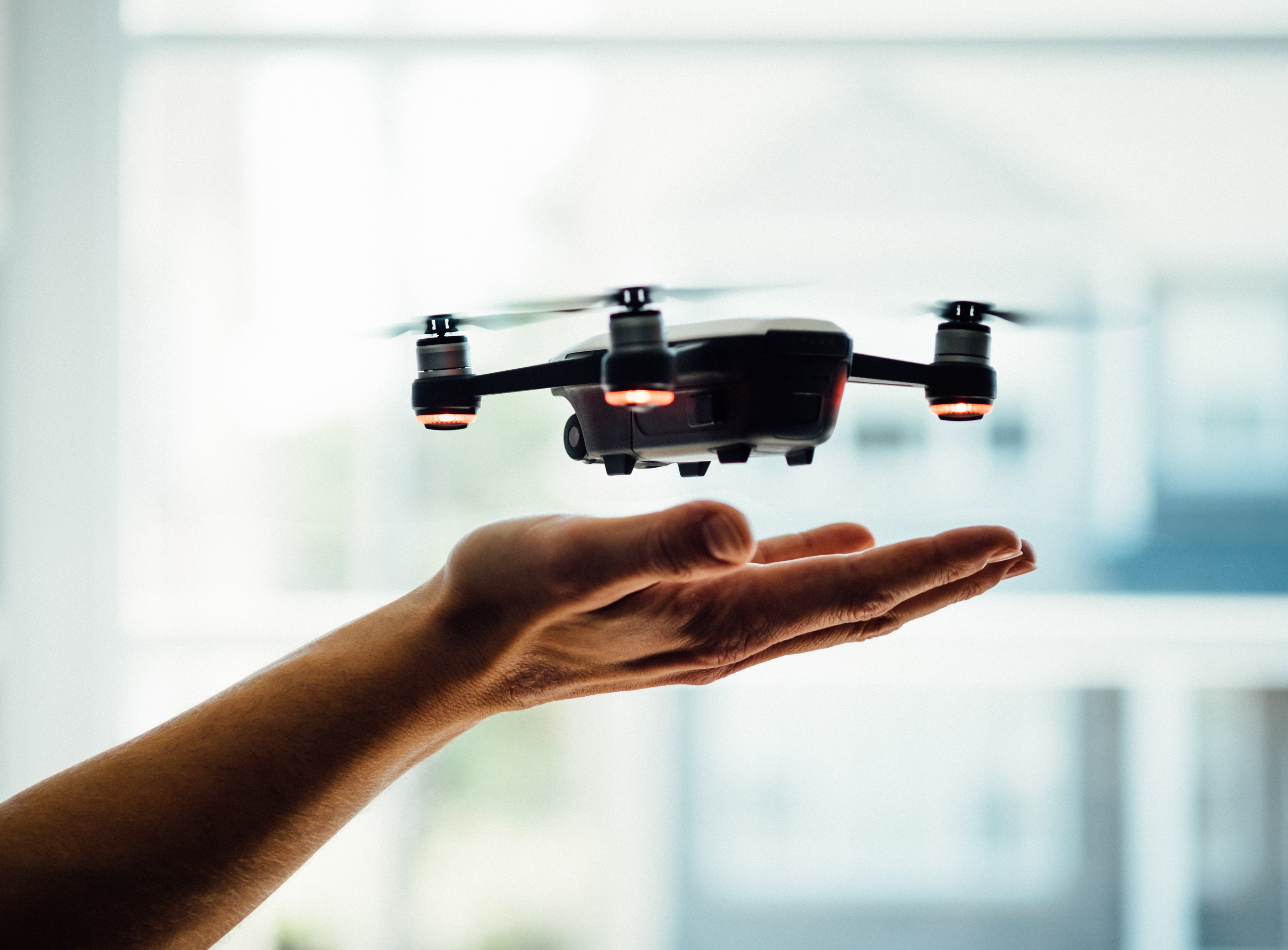 drone hovering above hand - tips for better real estate listing photos